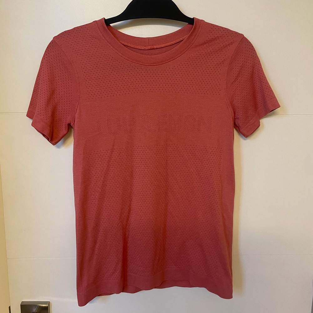Lululemon top in a orangeish, pinkish, red color. Size 4.